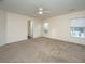Spacious bedroom with natural light, a ceiling fan, and an en-suite bathroom at 8849 Kellum Dr, North Charleston, SC 29420