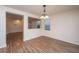 Dining room with natural light, hardwood floors, and open layout to kitchen and living area at 8849 Kellum Dr, North Charleston, SC 29420