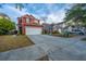 Inviting two-story home with a well-manicured lawn, long driveway and attached two car garage at 8849 Kellum Dr, North Charleston, SC 29420