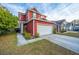 Attractive red home with a two car garage and landscaping at 8849 Kellum Dr, North Charleston, SC 29420