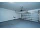 A spacious garage with painted floors, white walls, and an automatic door at 8849 Kellum Dr, North Charleston, SC 29420