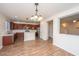 Open-concept kitchen with stainless steel appliances, granite countertops, and hardwood floors at 8849 Kellum Dr, North Charleston, SC 29420