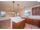 Open-concept kitchen with stainless steel appliances, granite countertops, and hardwood floors at 8849 Kellum Dr, North Charleston, SC 29420