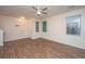 Open concept living room featuring modern ceiling fan, wood floors and bright natural light at 8849 Kellum Dr, North Charleston, SC 29420