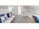 Bonus room featuring an accent wall, white futon, and gold end tables at 9000 Palmetto Dr # G-302, Isle of Palms, SC 29451