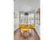 Bright dining area with contemporary light fixture, comfortable yellow seating, and modern decor at 9000 Palmetto Dr # G-302, Isle of Palms, SC 29451