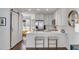 Modern kitchen with white cabinets, stainless steel appliances, and breakfast bar seating at 9000 Palmetto Dr # G-302, Isle of Palms, SC 29451