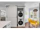 Convenient laundry area with stacked washer/dryer and sliding barn door, adjacent to the dining area at 9000 Palmetto Dr # G-302, Isle of Palms, SC 29451