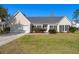 Charming single-story home with a well-manicured lawn, attached garage, and inviting entryway at 9234 Creedmore Rd, Summerville, SC 29485