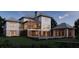 A stunning two-story home exterior featuring a pool, covered porch, and lush landscaping at 925 Fish Camp Rd, Charleston, SC 29492