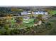 Scenic aerial view of the golf course, pond, and nearby clubhouse at 925 Fish Camp Rd, Charleston, SC 29492