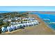 An aerial view of marsh views with two-story houses and a boat dock at 94 W 2Nd St, Folly Beach, SC 29439