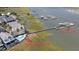 Aerial view showcasing waterfront homes with private boat lifts and a community pool near the riverfront at 94 W 2Nd St, Folly Beach, SC 29439