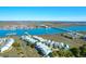 Stunning coastal aerial view of charming townhomes near a picturesque river with docks and a bridge at 94 W 2Nd St, Folly Beach, SC 29439