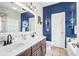 Modern bathroom with double sinks, a white toilet, and shiplap accent wall at 94 W 2Nd St, Folly Beach, SC 29439