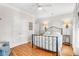 Comfortable bedroom with wood floors, ceiling fan, closet, and large window providing ample natural light at 94 W 2Nd St, Folly Beach, SC 29439