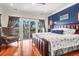 Bedroom with hardwood floors, armchair and balcony access at 94 W 2Nd St, Folly Beach, SC 29439