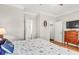Inviting bedroom featuring hardwood floors, neutral colors, and ensuite bathroom access at 94 W 2Nd St, Folly Beach, SC 29439
