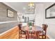 Cozy dining area with decorative wall, hardwood floors, and stylish lighting at 94 W 2Nd St, Folly Beach, SC 29439