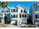 Charming two-story coastal home featuring a garage, white stairs, and black window shutters at 94 W 2Nd St, Folly Beach, SC 29439