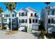 Charming two-story coastal home with a well-maintained yard, a two car garage, and steps to front door at 94 W 2Nd St, Folly Beach, SC 29439