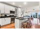 Bright kitchen with granite counters, island with bar seating, and stainless appliances at 94 W 2Nd St, Folly Beach, SC 29439