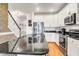 Well-lit kitchen featuring granite countertops, stainless appliances, and hardwood floors at 94 W 2Nd St, Folly Beach, SC 29439