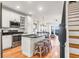 Open kitchen with white cabinetry, stainless steel appliances, and island seating at 94 W 2Nd St, Folly Beach, SC 29439