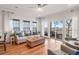 Bright living room with hardwood floors, a comfortable couch, and lots of natural light at 94 W 2Nd St, Folly Beach, SC 29439