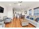 Bright living room featuring hardwood floors, stylish furniture, and modern ceiling fan at 94 W 2Nd St, Folly Beach, SC 29439