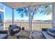 Relaxing screened-in porch with views of a calm waterfront and a comfortable seating area at 94 W 2Nd St, Folly Beach, SC 29439