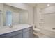 Bright bathroom featuring gray vanity, tub-shower combo, and large mirror at 103 Moscato Ln, Summerville, SC 29485