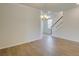 Bright, open-concept living room with hardwood floors, chandelier, and staircase at 103 Moscato Ln, Summerville, SC 29485