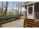 Back porch and steps leading down to a landscaped backyard surrounded by mature trees at 109 Nelson Ct, Summerville, SC 29485