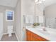 Cozy bathroom features a single sink vanity with warm wood cabinets, a toilet, and a combination tub/shower at 109 Nelson Ct, Summerville, SC 29485