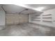 Spacious garage with concrete floor, shelves, and an automatic door providing secure parking and storage at 109 Nelson Ct, Summerville, SC 29485