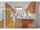 An eat-in kitchen with wood cabinets and a breakfast nook is bathed in natural light at 109 Nelson Ct, Summerville, SC 29485