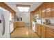 The well-lit kitchen features wood cabinets, white appliances, and hardwood floors at 109 Nelson Ct, Summerville, SC 29485