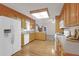 Bright kitchen with wood cabinets, white appliances, and hardwood floors at 109 Nelson Ct, Summerville, SC 29485