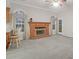 Bright living room featuring a classic brick fireplace, large windows and neutral carpeting at 109 Nelson Ct, Summerville, SC 29485