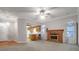 Open-concept living room featuring a fireplace and seamless flow into the adjacent kitchen at 109 Nelson Ct, Summerville, SC 29485