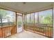Cozy screened porch with wood flooring and railing, offering serene views of the landscaped backyard and trees at 109 Nelson Ct, Summerville, SC 29485