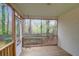 Inviting screened-in porch with wooden deck and views of the lush backyard and mature trees at 109 Nelson Ct, Summerville, SC 29485