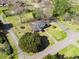 Aerial view of a charming home, surrounded by mature trees and a well-maintained yard with trampoline at 1115 O T Wallace Blvd, Moncks Corner, SC 29461