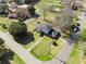 Aerial view of a home on a large lot with mature trees, neighboring houses and a swimming pool at 1115 O T Wallace Blvd, Moncks Corner, SC 29461