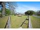 Spacious backyard featuring a large green lawn and wooden deck, perfect for outdoor activities and relaxation at 1115 O T Wallace Blvd, Moncks Corner, SC 29461