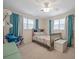 Inviting bedroom with ceiling fan, carpeted floors, a plush bed, and plenty of natural light at 1115 O T Wallace Blvd, Moncks Corner, SC 29461