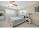 Relaxing bedroom with neutral walls, ceiling fan, carpeted floors, and natural light from two windows at 1115 O T Wallace Blvd, Moncks Corner, SC 29461