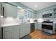 Updated kitchen features stainless steel appliances and white countertops, with lots of light and hardwood floors at 1115 O T Wallace Blvd, Moncks Corner, SC 29461