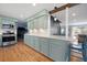 The eat-in kitchen flows to living room, featuring updated appliances, counters, and stylish breakfast bar at 1115 O T Wallace Blvd, Moncks Corner, SC 29461